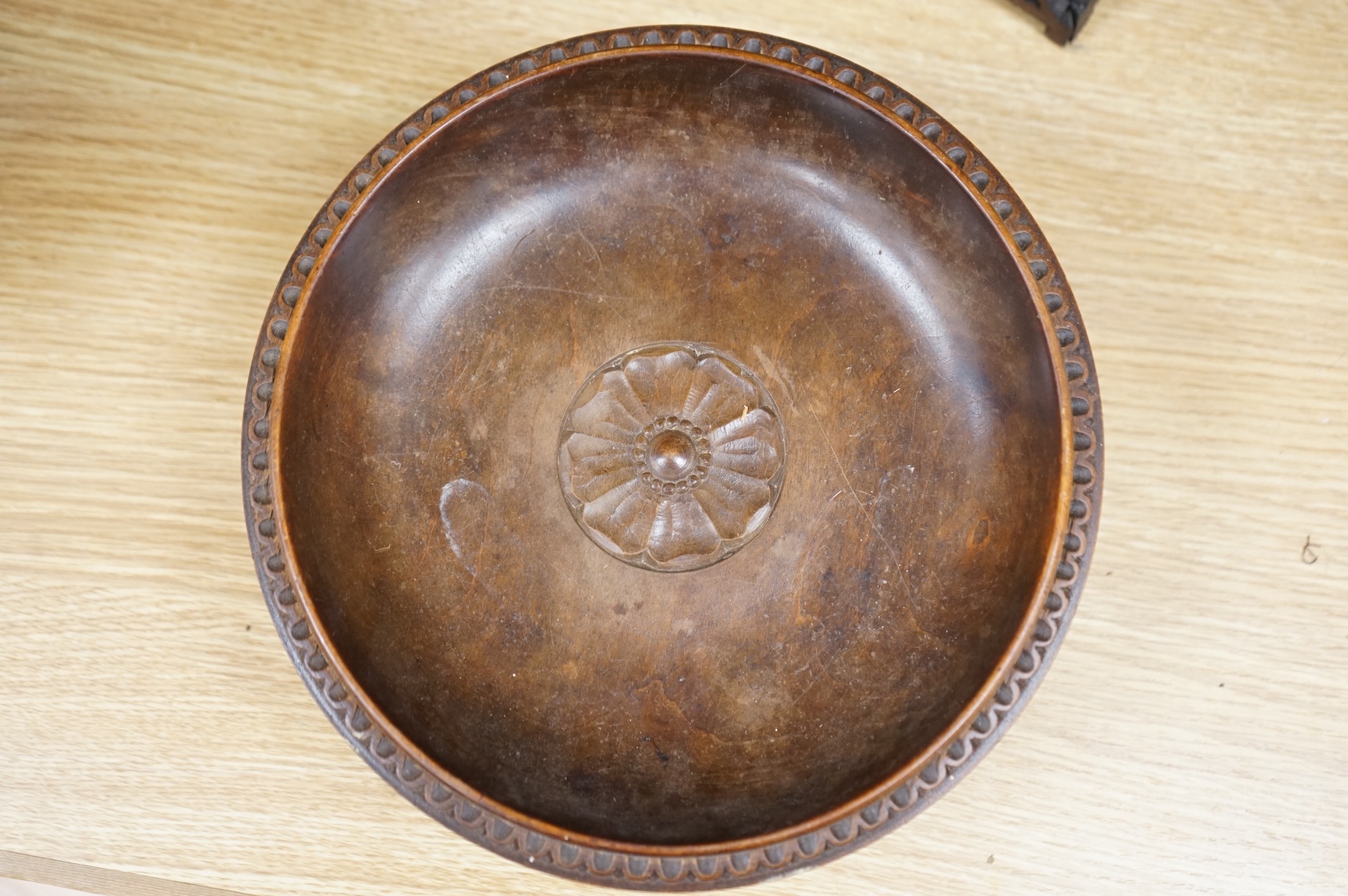 An early 20th century Black Forest carved walnut musical footed dish together with a model of a house (2)